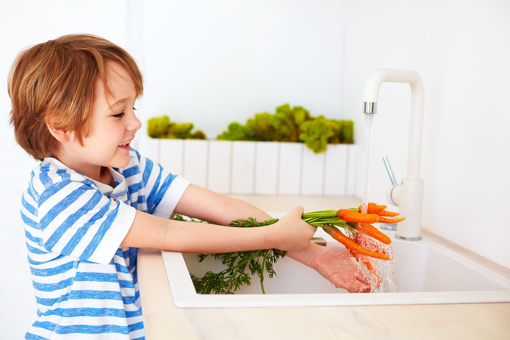 A child washing vegetables with water that has had water analysis in MD